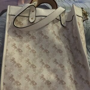 Coach purse with horse carriage on it ￼